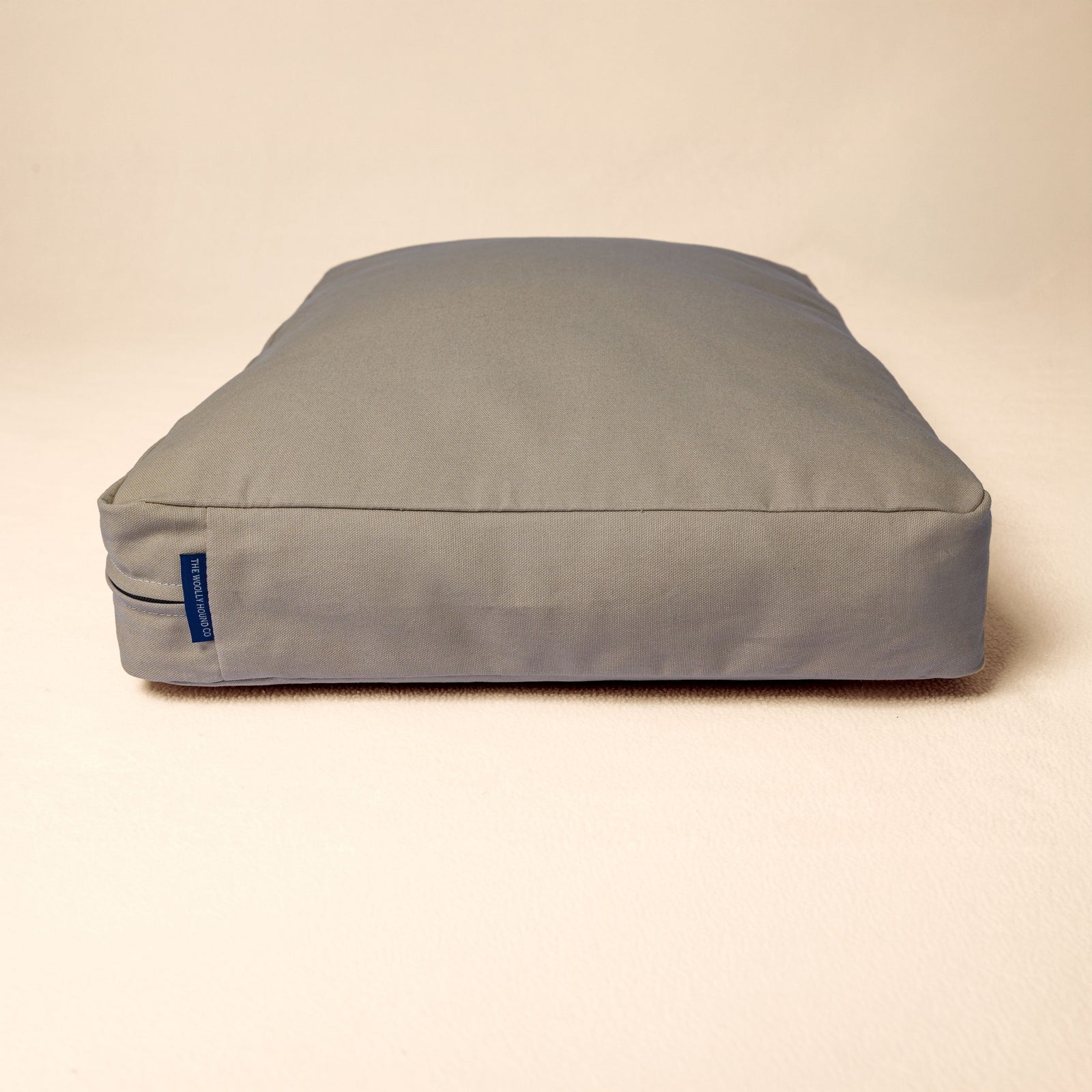 Side profile of The Woolly Hound Classic Bed showing its plush natural filling and supportive loft.