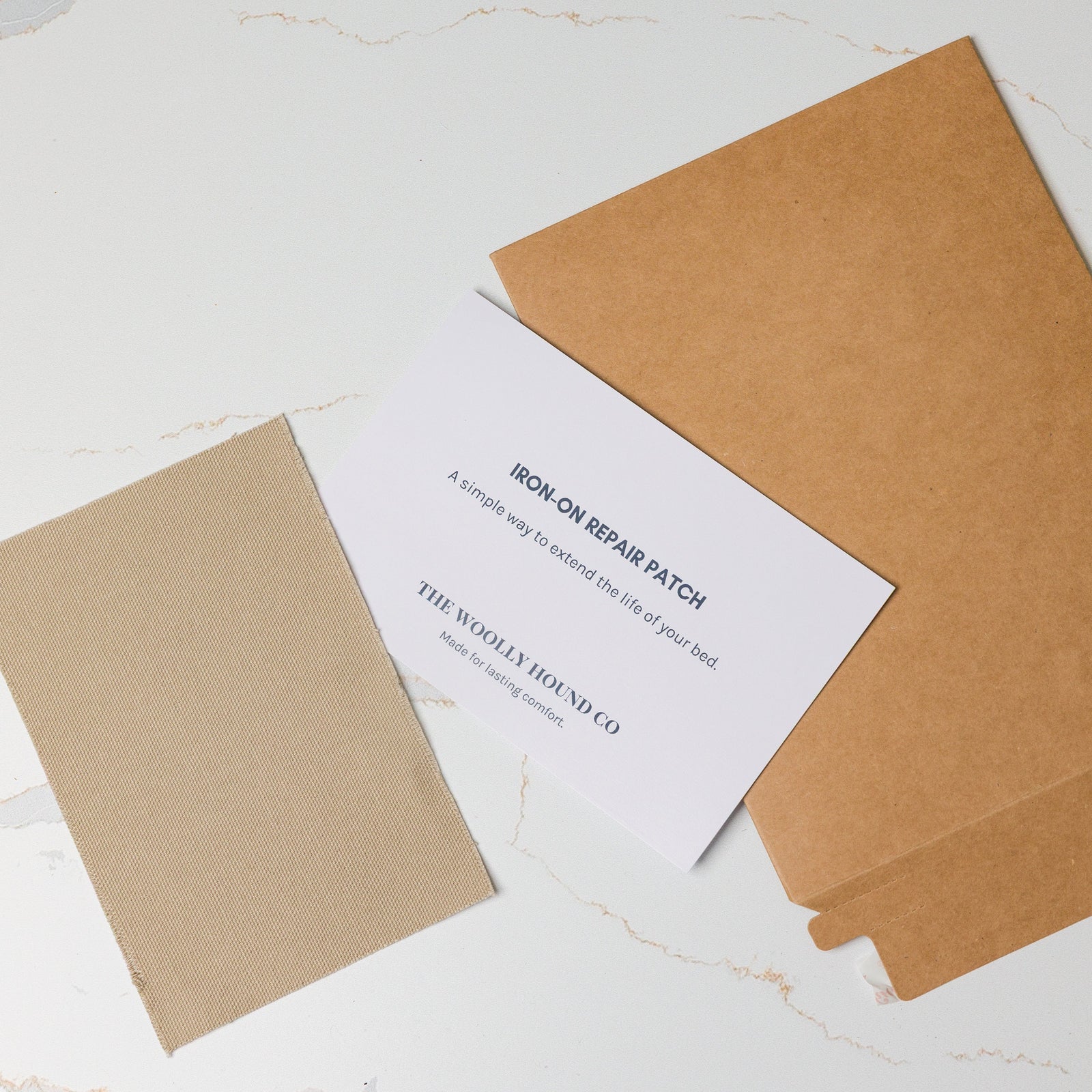 Iron-on bed repair patch kit with patch and instruction card.