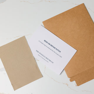 Iron-on bed repair patch kit with patch and instruction card.