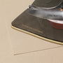 Ironing an organic cotton repair patch onto a Classic Bed Cover.