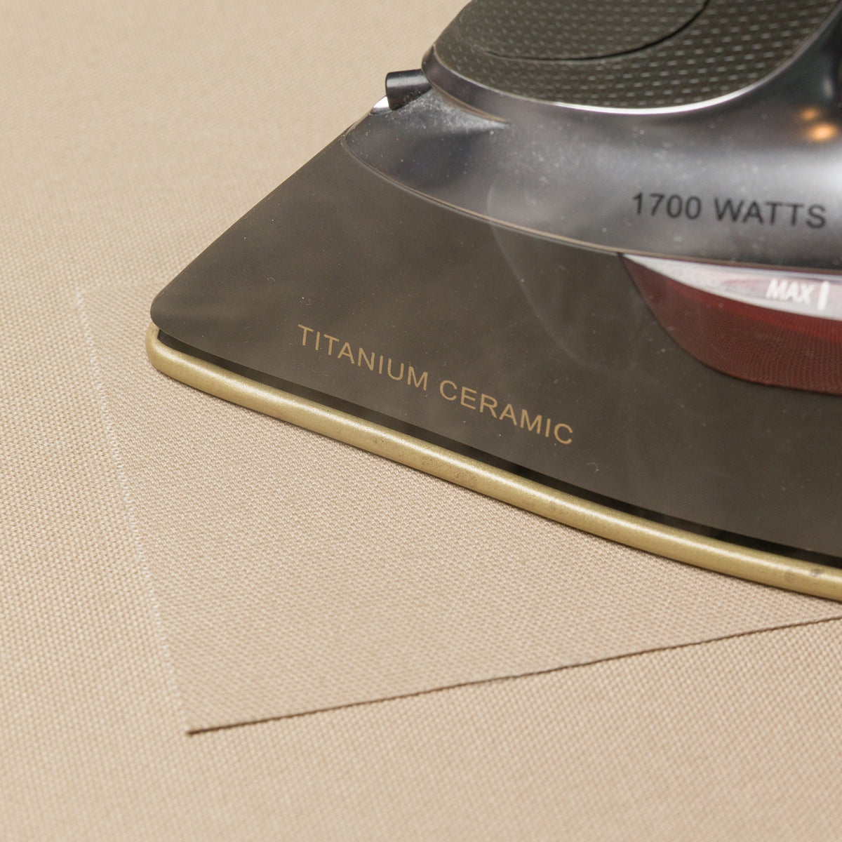 Ironing an organic cotton repair patch onto a Classic Bed Cover.