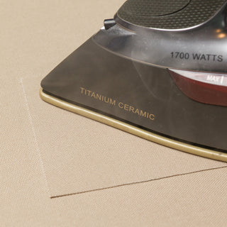 Ironing an organic cotton repair patch onto a Classic Bed Cover.