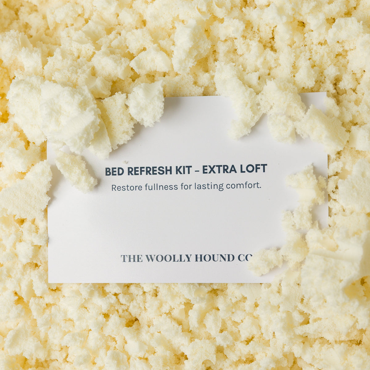 Close-up of natural shredded latex used to refresh The Woolly Hound bed insert with instruction card.